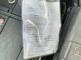 a car ' s engine with its hood open and a paper attached to it