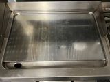a metal pan sitting on top of a stove