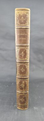 an old book sitting on top of a table next to a gray background