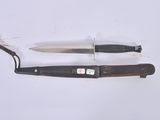 two knives that are laying next to each other on a table