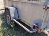 a small trailer with a cage on the back of it
