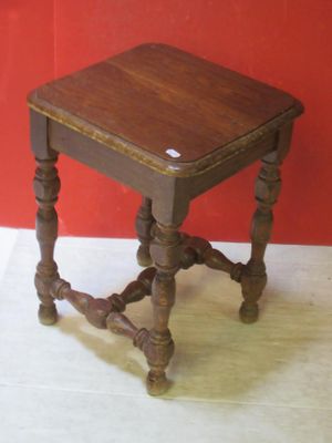 a small table with a wooden top on a white floor