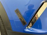 a sticker on the front of a blue car with a sticker on it