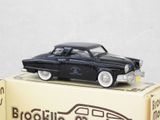 a black toy car sitting on top of a box