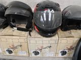 many boxes of helmets sitting on top of each other