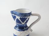a blue and white coffee cup on a white table