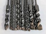 a bunch of drill bits sitting on top of a table
