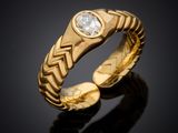 a close up of a gold ring with a diamond in the center