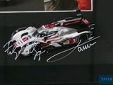 a signed picture of a race car on display