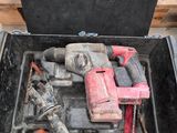 a tool box with tools inside of it on the floor