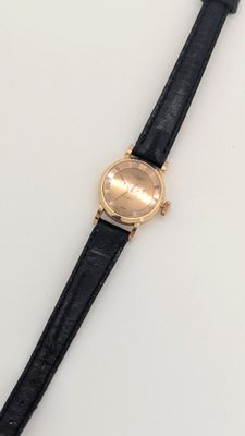 gros plan d'une montre-bracelet sur une surface blanche