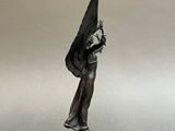 statue of a woman holding a black umbrella on a marble base