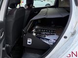 a small white car with the door open and the back door open