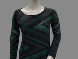 the mannequin is wearing a green and black top