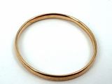 an image of a close up of a gold ring on a white surface