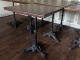 two tables that are sitting in the middle of a room