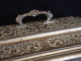 a silver box with a handle on a black background