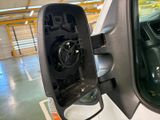 a side view mirror of a truck with a speaker in it