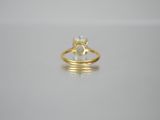a close up of a gold ring with a diamond on it