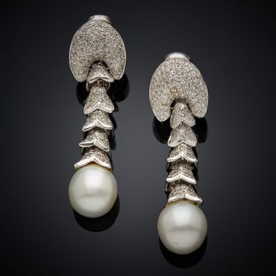 a pair of pearl and diamond earrings
