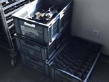 a stack of crates sitting next to a window in a room