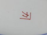 a close up of a white plate with a red line on it