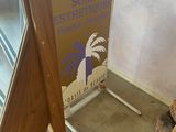 a sign in front of a fire place with a firewood