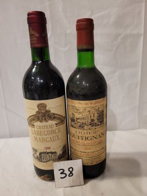 two bottles of wine sitting next to each other on a table