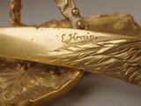 a close up of a pair of scissors on a gold plate