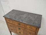 a marble top dresser with drawers and a marble top top