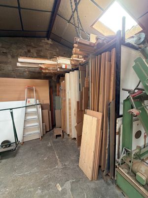 several pieces of wood are stacked up in a room with a ladder