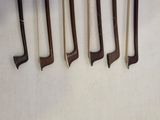 five different types of golf clubs hanging on a wall