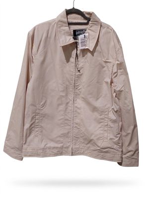 a beige jacket hanging on a hanger on a white wall