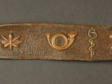 an image of a gold bracelet with a variety of symbols on it