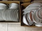 many plates and bowls in a box on the floor