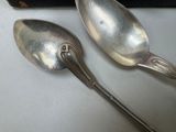 two spoons sitting next to each other on a table