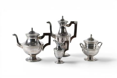 three silver teapots and two silver cups on a white surface