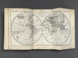 an old map of the world on display in a museum