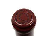 a close up of a bottle of wine on a white surface