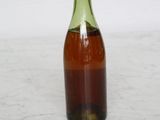a small bottle of syrup sitting on a table