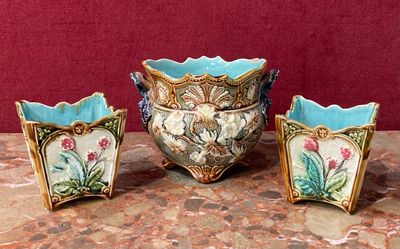 three vases sitting on a table with a red background