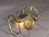 a glass table with a gold spider on it