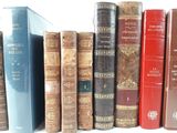 many books that are lined up on a shelf