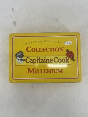 yellow tin box of captain cook millenium with a red bird on top