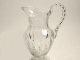 a glass pitcher that is sitting on a table