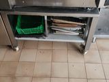 a silver oven that is open on a tiled floor