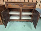 an old wooden cabinet with two doors open