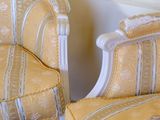 yellow and white striped chairs in a corner of a room