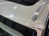 a measuring tape on the hood of a white car