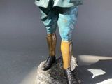 a statue of a man standing on a rock
